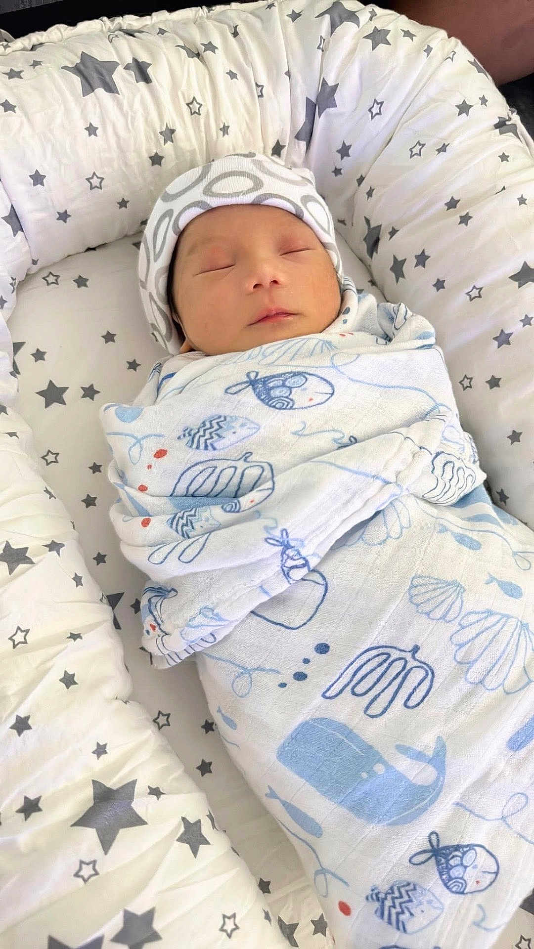 Kayden is registered to the contest to win money with this photo: newborn, baby, sleeping, swaddle, hat, blanket, stars, pattern, cozy, nest, infant, peaceful, cute, soft, rest, child, wrapped, indoor, portrait, calm
