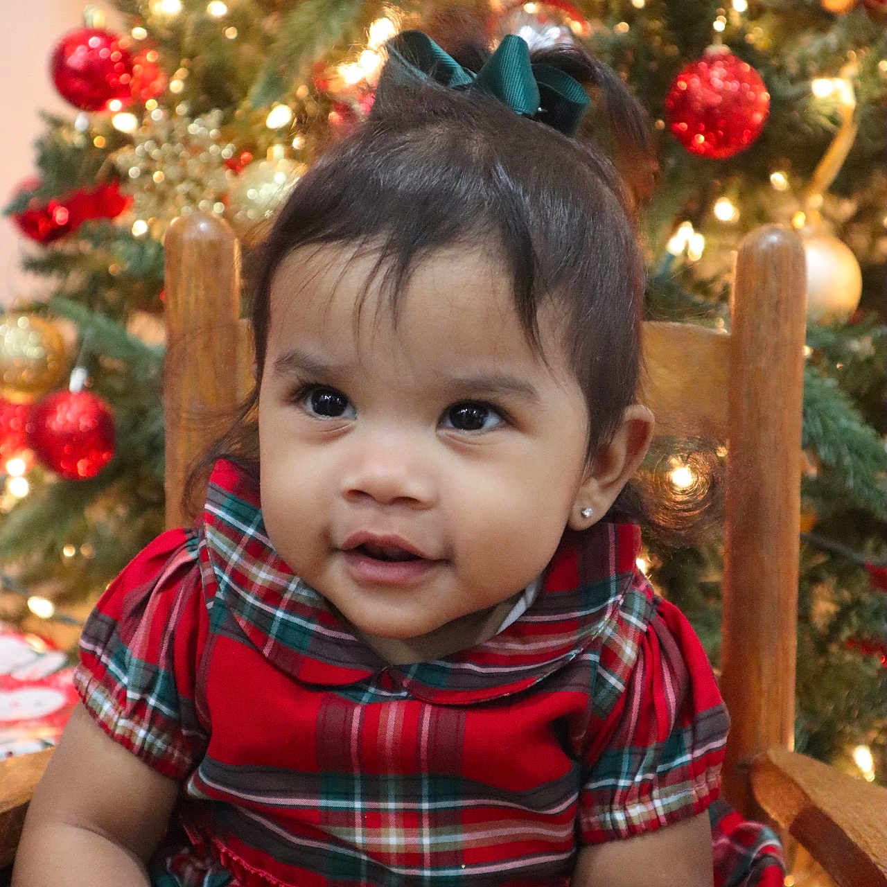 Emmy is registered to the contest to win money with this photo: accessories, baby, clothing, conifer, couch, face, fir, furniture, happy, head, lighting, ornament, pants, person, photography, plant, portrait, pottedplant, smile, tree