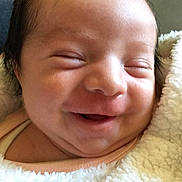 Erika joined the competition — help win amazing prizes! baby, newborn, smiling, face, blanket, infant, closeup, soft, cute, sleeping, wrapped, skin, head, happy, portrait, child, young, peaceful, cozy, warm