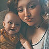 baby, child, woman, selfie, portrait, smile, pout, indoor, casual, clothing, onesie, polka_dot, necklace, curly_hair, light, face, skin, happy, toddler, family