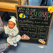 Adam joined the competition — help win amazing prizes! newborn, baby, infant, sleeping, portrait, graduation, chalkboard, milestone, nicu, hospital, onesie, hat, blanket, toy_fish, adult_hand, stroller, chair, indoor, floor, birthday