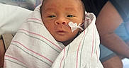 Adam is registered to the contest to win money with this photo: adult, baby, baby_bandage, blanket, caregiver, child, closeup, eyes_open, face, heart_shape, hospital, hospital_bed, indoor, infant, medical_tape, newborn, photography, portrait, striped_blanket, swaddled