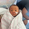 Adam is registered to the contest to win money with this photo: newborn, baby, infant, child, hospital, blanket, swaddled, striped_blanket, face, portrait, eyes_open, baby_bandage, medical_tape, heart_shape, adult, caregiver, indoor, hospital_bed, photography, closeup