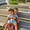 children, baby, toddler, siblings, sibling_bond, outdoor, bench, portrait, smiling, happy, family, 抱抱, braids, curly_hair, floral_dress, striped_outfit, pacifier, garden, sunlight, patio