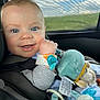 Alexis participe au concours pour gagner de l'argent avec cette photo : baby, blue_eyes, car_seat, child, clothing, cute, daylight, face, happy, indoors, infant, looking_at_camera, plush_toy, portrait, seatbelt, smile, toy, window, young_child, car