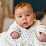 baby, infant, blue_eyes, sweater, knitted_blanket, curious, face, hands, closeup, portrait, indoors, warm, soft_light, child, cute, young, person, skin, expression, home