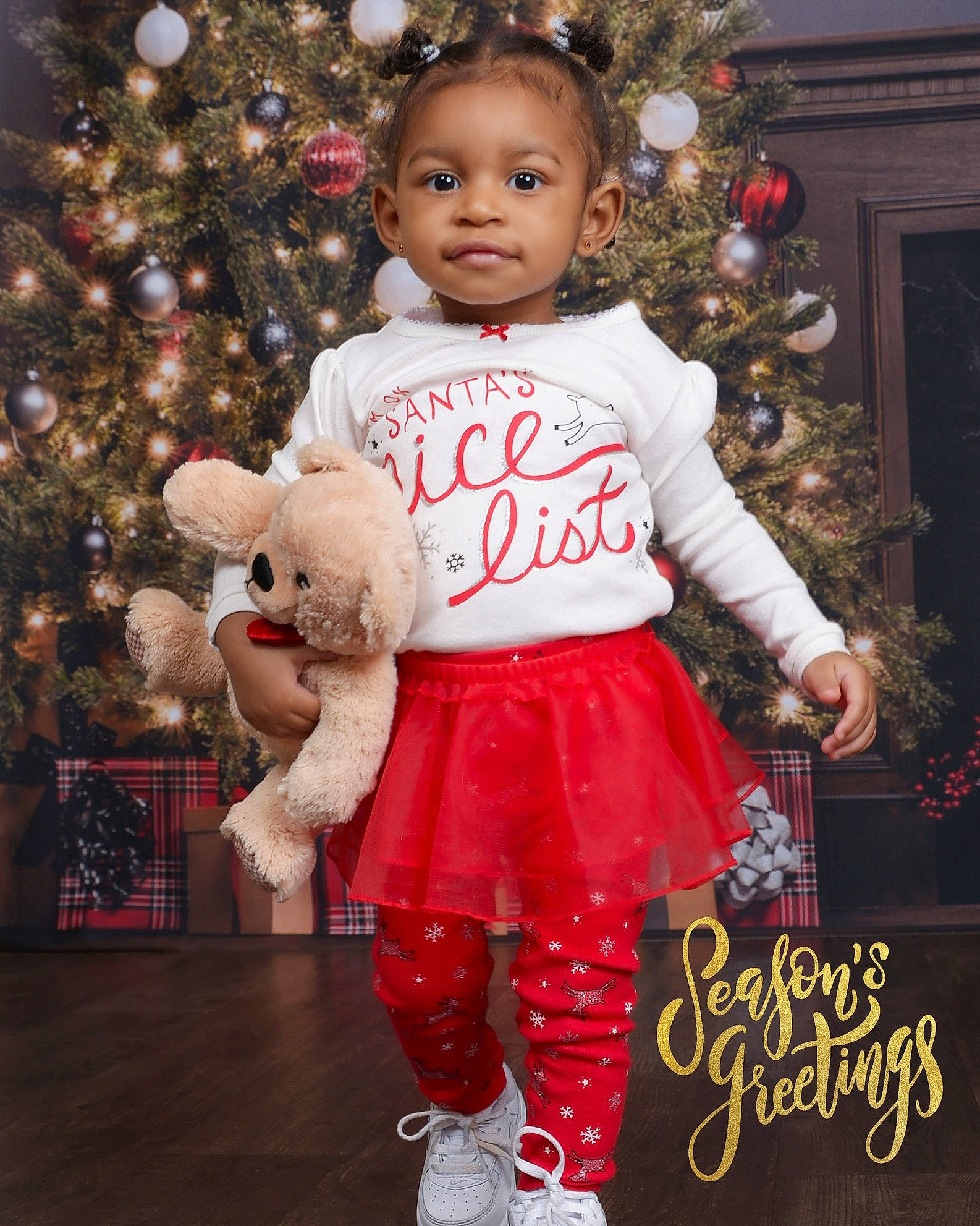 Aria is registered to the contest to win money with this photo: baby, baby_toddler_clothing, child, christmas, christmas_decoration, christmas_eve, christmas_ornament, christmas_tree, event, happy, head, holiday, holiday_ornament, human_body, ornament, person, red, sleeve, toddler, white