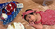 Samira is registered to the contest to win money with this photo: baby, balloon, birthday_cake, bouquet, cake, candle, celebration, closeup, colorful, festive, first_birthday, flowers, headband, infant, laying_down, patriotic, red_gingham, soft_surface, sprinkles, usa