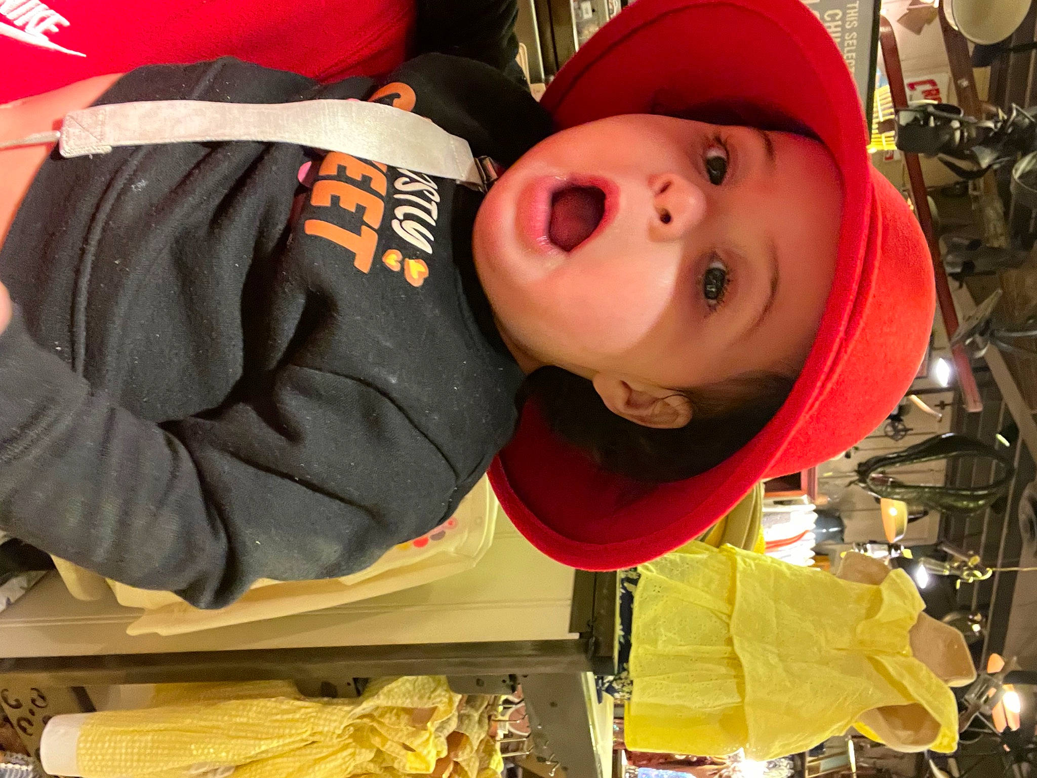 Melani joined the competition — help win amazing prizes! baby, beanie, cap, carmine, child, fun, hat, headwear, helmet, person, personal_protective_equipment, surprise, toddler, tradition, yellow