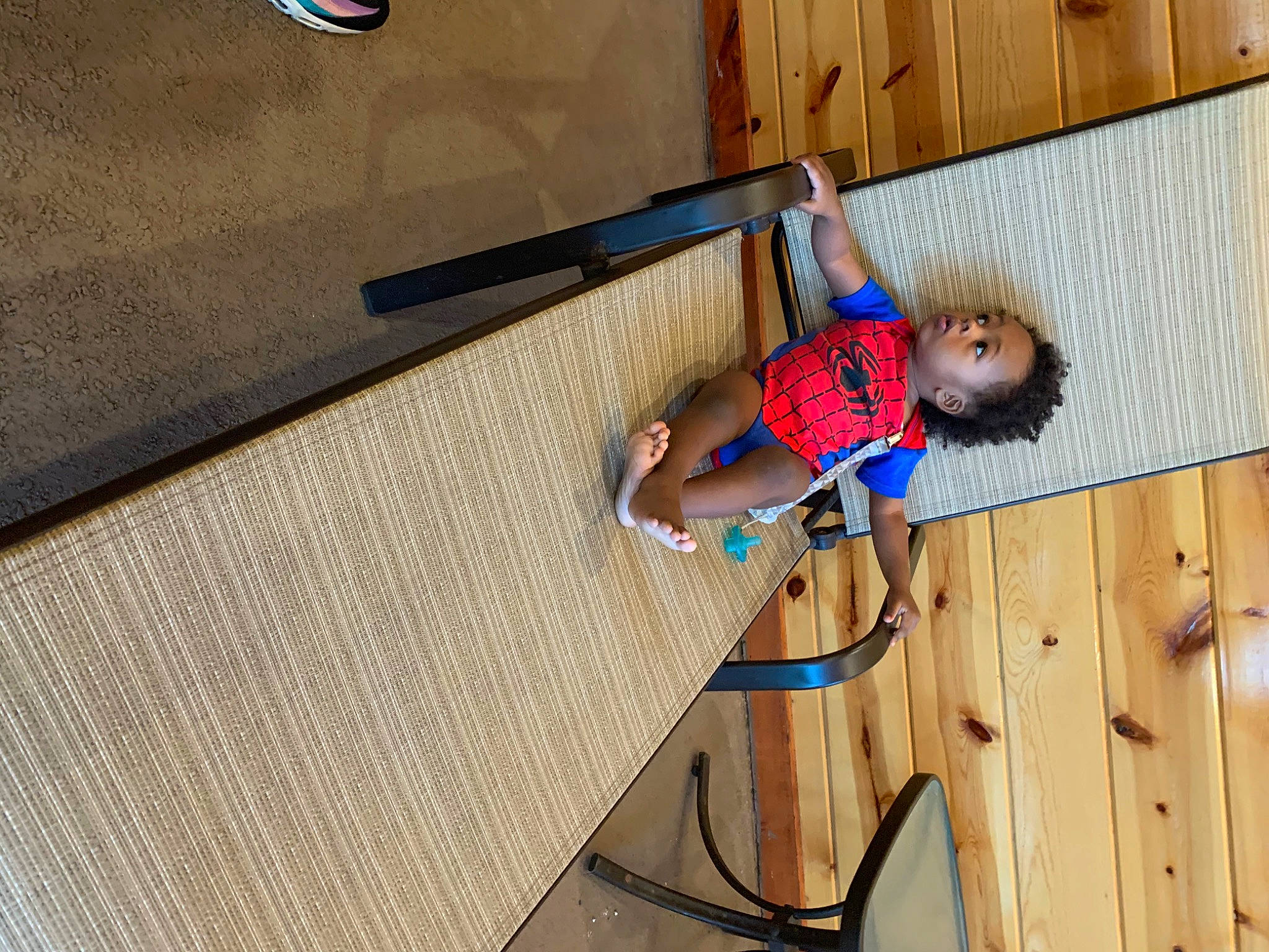 Knox is registered to the contest to win money with this photo: adventure, balance, child, elbow, electric_blue, fun, hardwood, human_leg, knee, leisure, person, recreation, shorts, standing, surprise, t_shirt, thigh, toddler, varnish, wire