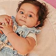 Mila participe au concours pour gagner de l'argent avec cette photo : baby, infant, child, cute, denim, clothing, curly_hair, laying_down, blanket, soft_toy, indoor, portrait, hands, expression, face, comfortable, pink, white, young, person