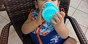 Yeshua joined the competition — help win amazing prizes! baby, blue, cartoon_character, child, cute, drink, hand, life_jacket, orange, outdoor, patio, sandals, sippy_cup, sitting, summer, tile_floor, toddler, water_safety, wicker_chair, young_child
