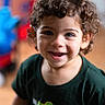 Yeshua is registered to the contest to win money with this photo: child, toddler, curly_hair, smiling, blue_eyes, sesame_street, tshirt, indoor, portrait, happy, cute, person, closeup, playful_background, young_child, casual_clothing, bright, colorful, face, cheerful