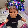 Yeshua joined the competition — help win amazing prizes! toddler, child, smiling, christmas_tree, holiday, gift_bag, indoor, festive, lights, black_clothing, calvin_klein, happy, cute, floor, decorations, present, sitting, young_child, holiday_season, christmas
