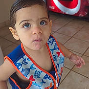 Yeshua is registered to the contest to win money with this photo: blue_eyes, casual, child, coca_cola, colorful_clothing, curious_expression, face, indoor, life_vest, person, portrait, sandals, shorts, small_hand, standing, tile_floor, toddler, vending_machine, wet_hair, young_child