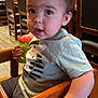 Jaxten joined the competition — help win amazing prizes! toddler, child, high_chair, sippy_cup, green_cup, wooden_furniture, restaurant, indoor, curious, short_sleeve_shirt, casual_clothing, brown_eyes, light_skin, short_hair, face, hand, wood_floor, seated, expression, person