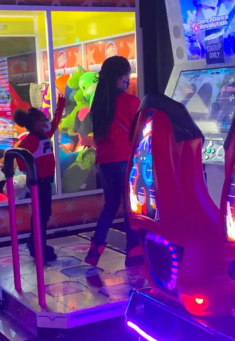 Kennedy joined the competition — help win amazing prizes! arcade_game, art, blue, electric_blue, electronic_device, entertainment, event, fun, games, leisure, light, machine, magenta, person, pink, purple, recreation, snapshot, technology, video_game_arcade_cabinet