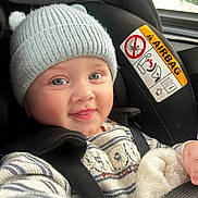 Isaya participe au concours pour gagner de l'argent avec cette photo : baby, child, car_seat, hat, knit_hat, smile, happy, face, blue_eyes, clothing, seatbelt, striped_sweater, cozy, indoor, portrait, infant, cute, warm, car, seat