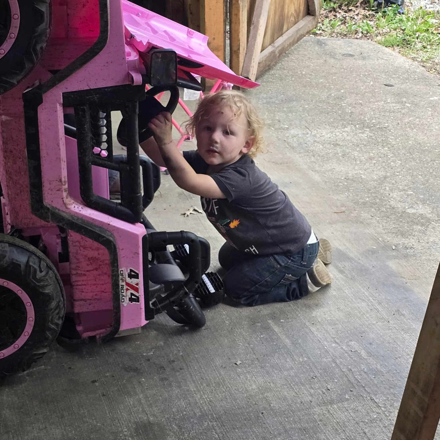 Cambrian joined the competition — help win amazing prizes! 4x4, adult, casual_clothing, child, concrete_floor, curly_hair, dirt, footwear, garage, grass, hand, jeans, kneeling, outdoor, pink, play, short_sleeve_shirt, toddler, toy_vehicle, wooden_wall