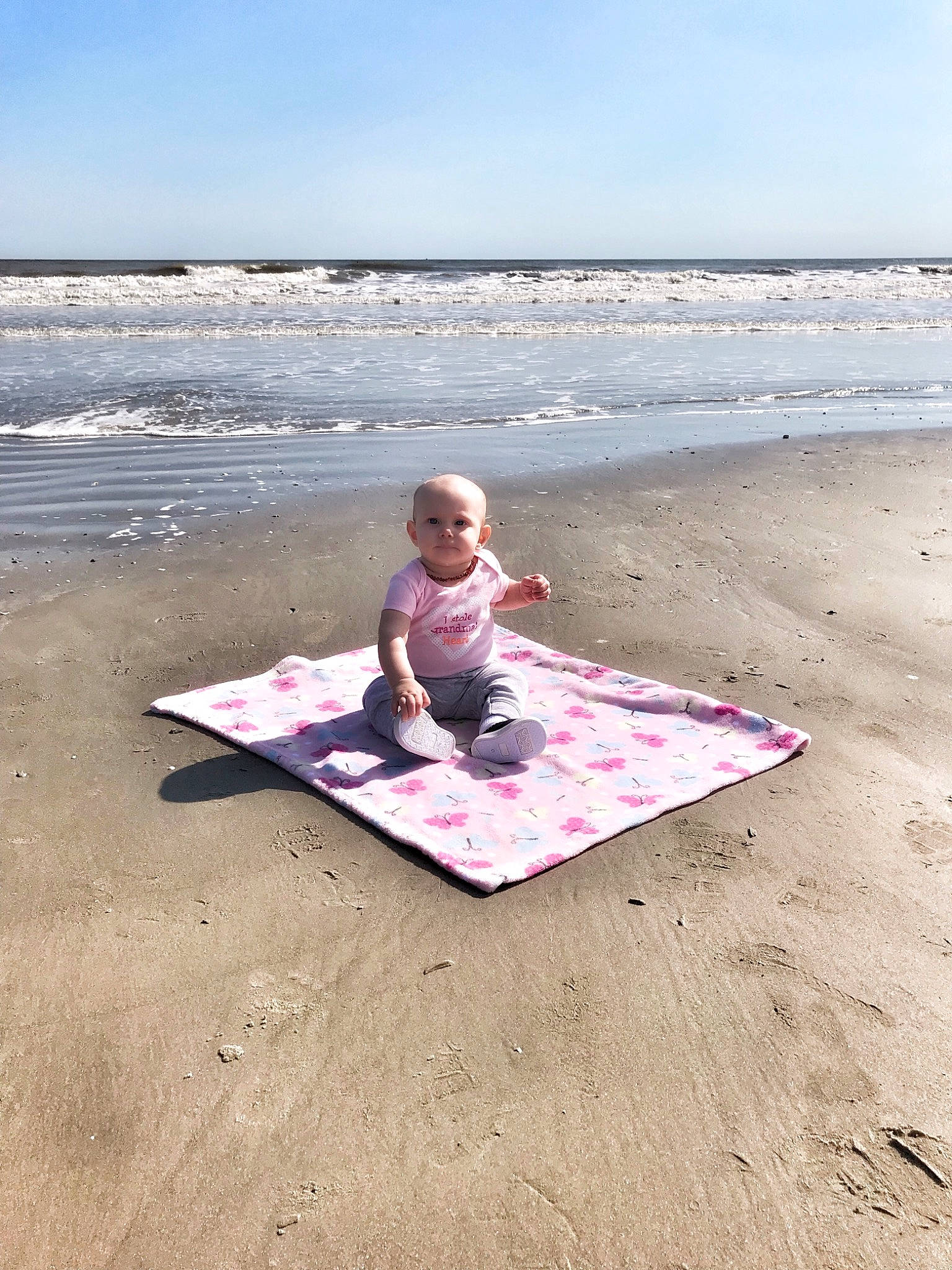 Mckenzie is registered to the contest to win money with this photo: beach, child, coast, fun, horizon, leisure, ocean, person, physical_fitness, pink, play, recreation, sand, sea, shore, sitting, summer, toddler, vacation, wave