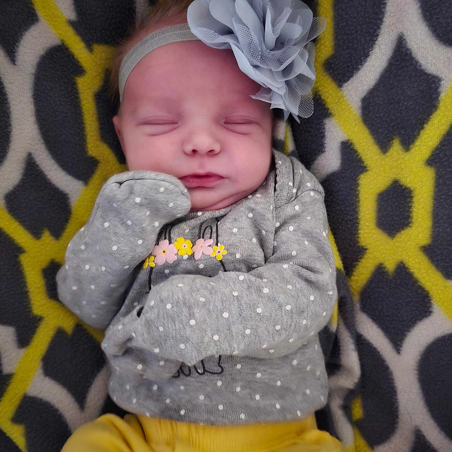 Axley joined the competition — help win amazing prizes! baby, blanket, child, clothing, cozy, cute, flower, headband, indoor, infant, pattern, peaceful, polka_dot, portrait, resting, sleeping, soft, sweater, yellow_pants, young