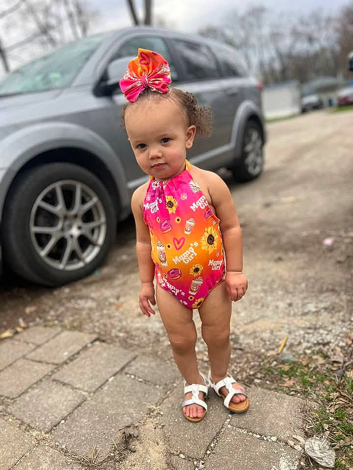 Lanaya joined the competition — help win amazing prizes! car, child, clothing, face, female, footwear, girl, hair, head, machine, person, photography, sandal, sitting, sleeve, standing, tire, transportation, vehicle, wheel