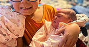 Ta'Vion is registered to the contest to win money with this photo: accessories, baby, blanket, childbirth, face, family, glasses, happy, head, newborn, people, person, photography, portrait, smile