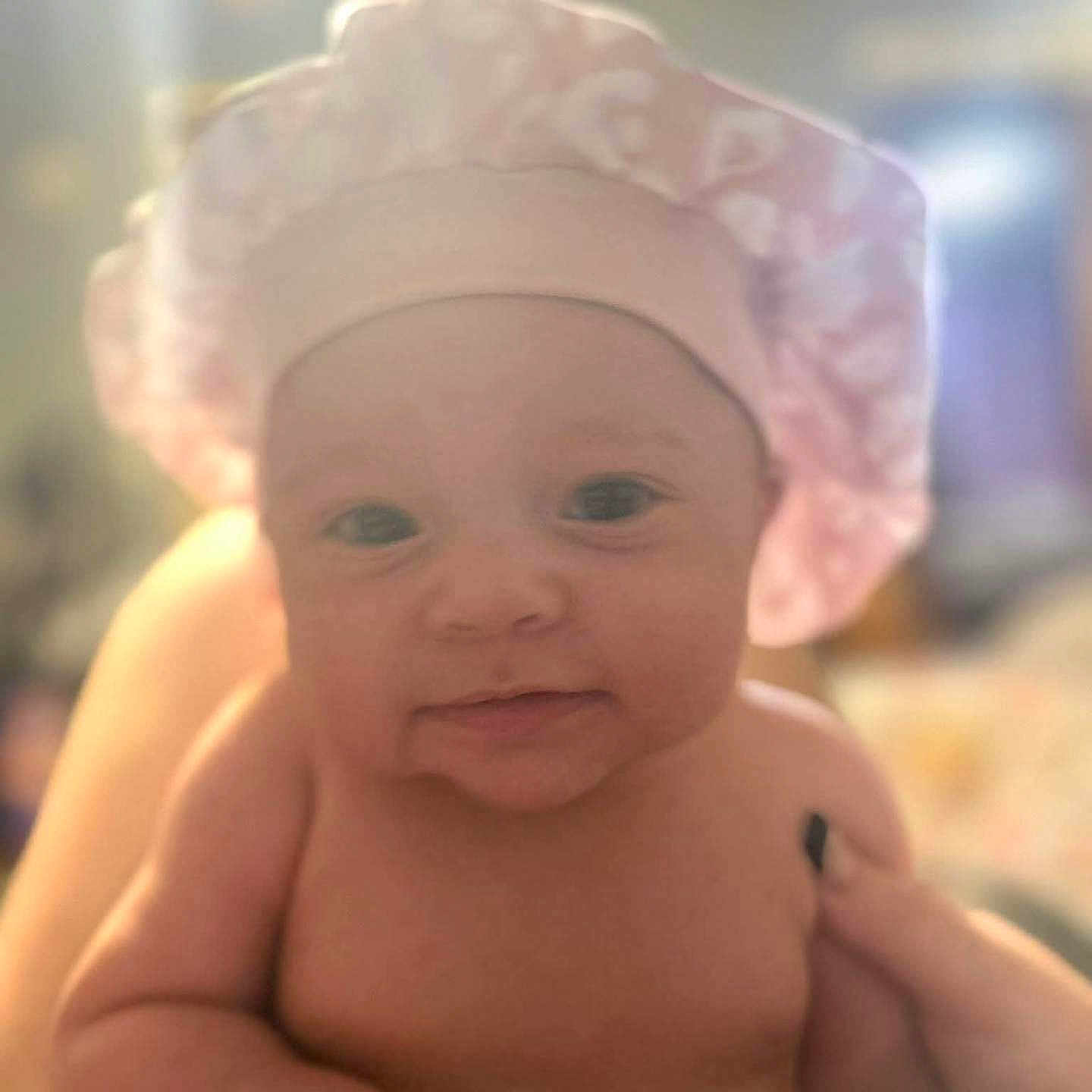 Zuriah joined the competition — help win amazing prizes! adorable, baby, child, chubby, closeup, cute, expression, face, hand, headwear, human, indoors, infant, newborn, person, pink_shower_cap, portrait, skin, smile, soft_light