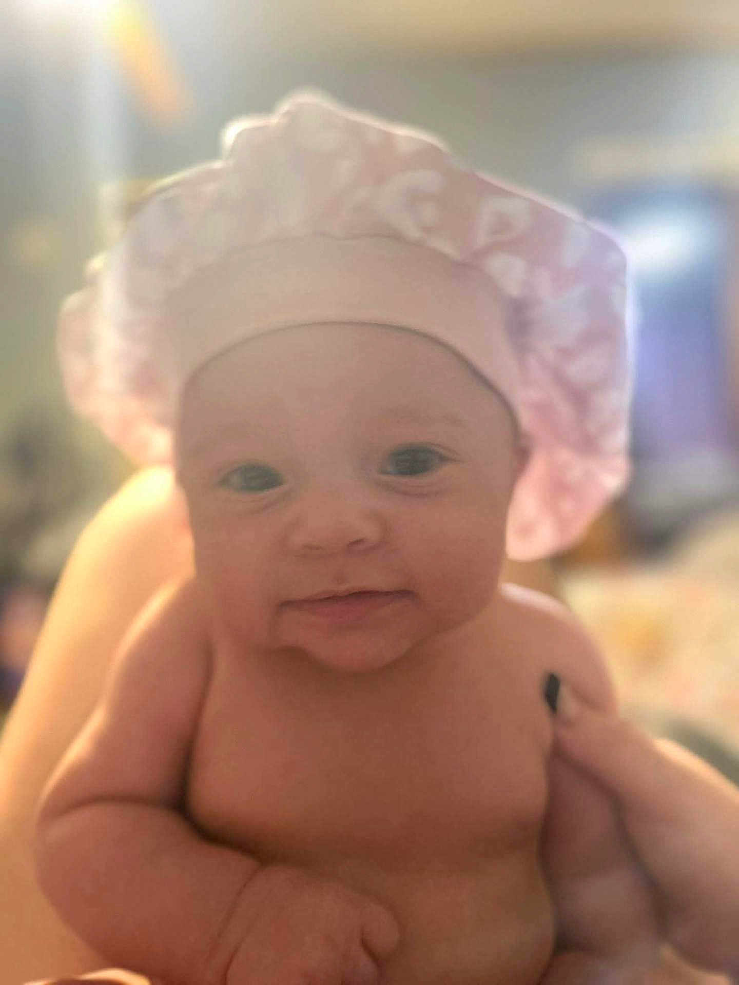 Zuriah joined the competition — help win amazing prizes! adorable, baby, child, chubby, closeup, cute, expression, face, hand, headwear, human, indoors, infant, newborn, person, pink_shower_cap, portrait, skin, smile, soft_light