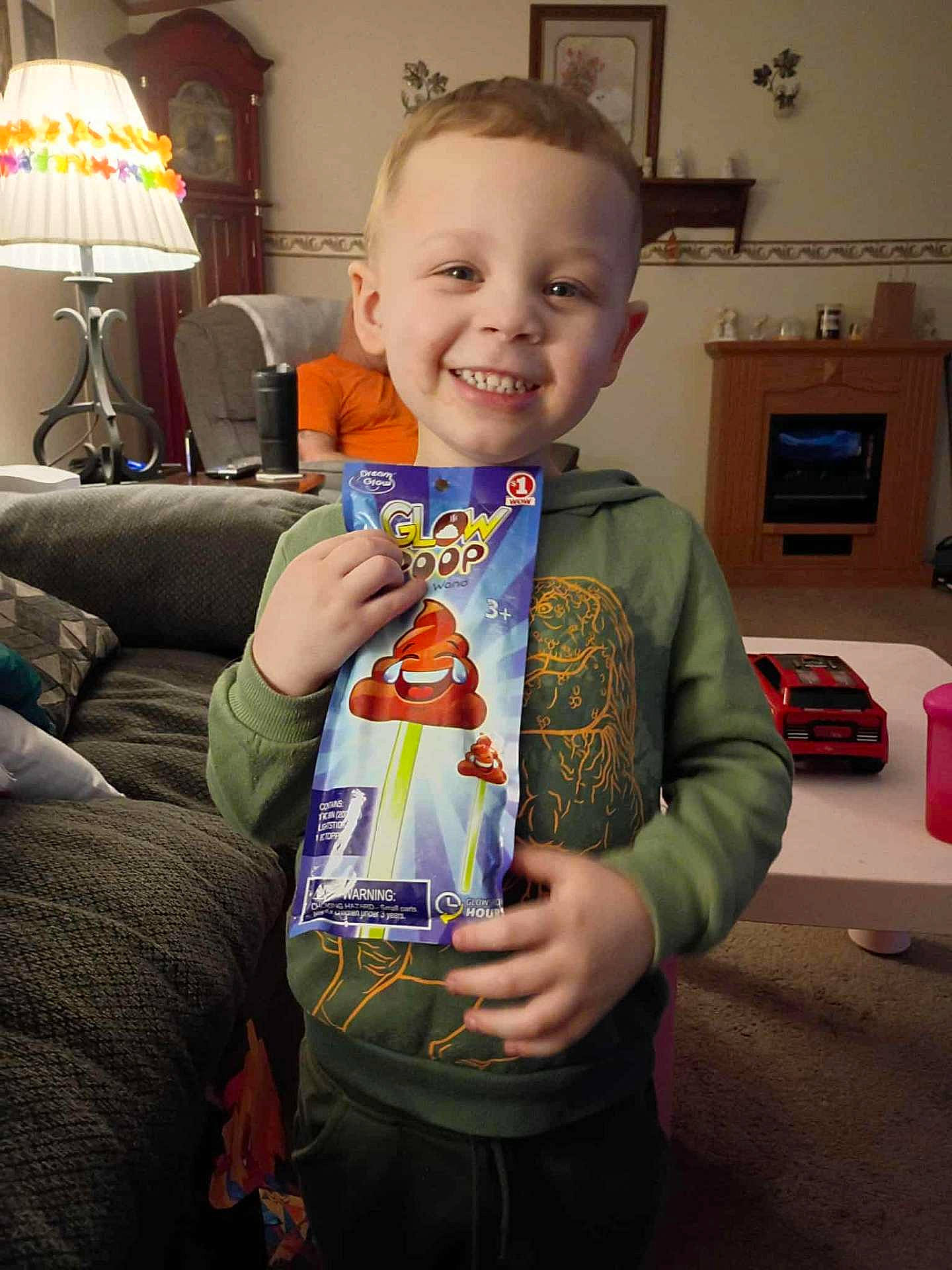 Ja'Chari joined the competition — help win amazing prizes! boy, car_toy, child, couch, cute, furniture, green_hoodie, happy, home, indoor, lamp, living_room, lollipop, package, person, portrait, smile, sweatshirt, table, toy