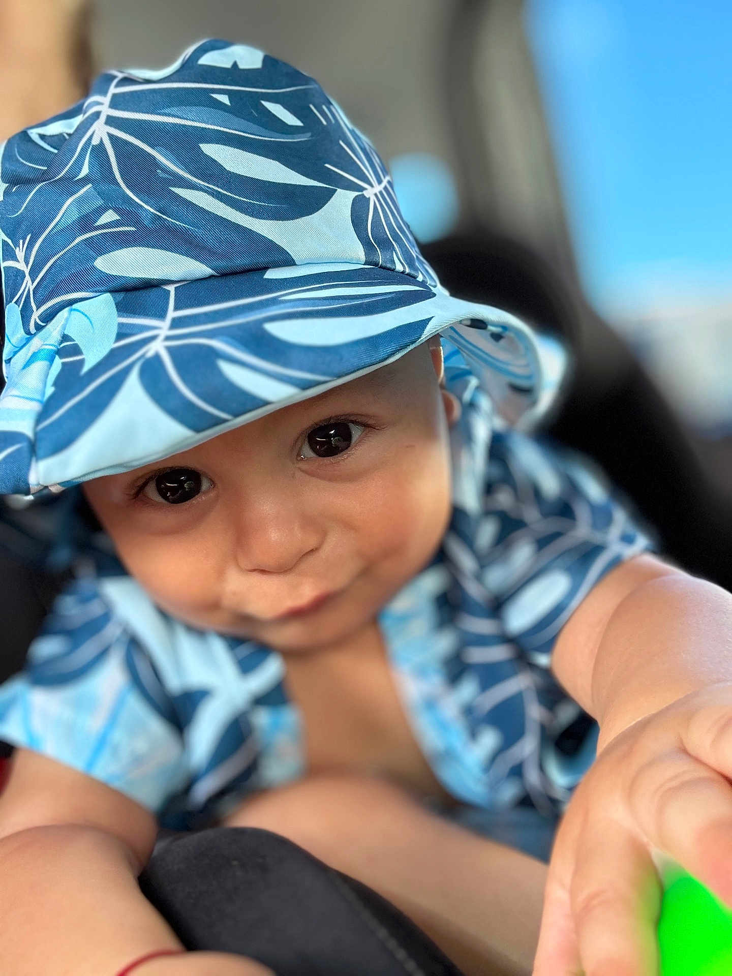 Apollo joined the competition — help win amazing prizes! baby, child, face, hat, blue, patterned_clothing, smile, cute, infant, portrait, close_up, hand, skin, eyes, sun_hat, apparel, young_child, curious, baby_girl_or_boy, soft_background