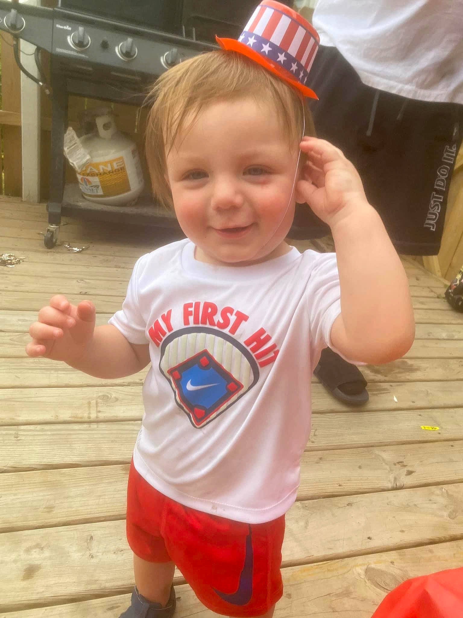 Reymon is registered to the contest to win money with this photo: baby, baby_toddler_clothing, child, costume_hat, face, facial_expression, fictional_character, floor, flooring, fun, happy, joy, orange, person, red, skin, sleeve, smile, sportswear, t_shirt