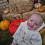 David is registered to the contest to win money with this photo: baby, child, pumpkin, hay_bale, outdoor, fall, autumn, smiling, knitted_clothing, white_sweater, grass, seasonal, festive, cute, portrait, nature, harvest, colorful, cozy, holiday