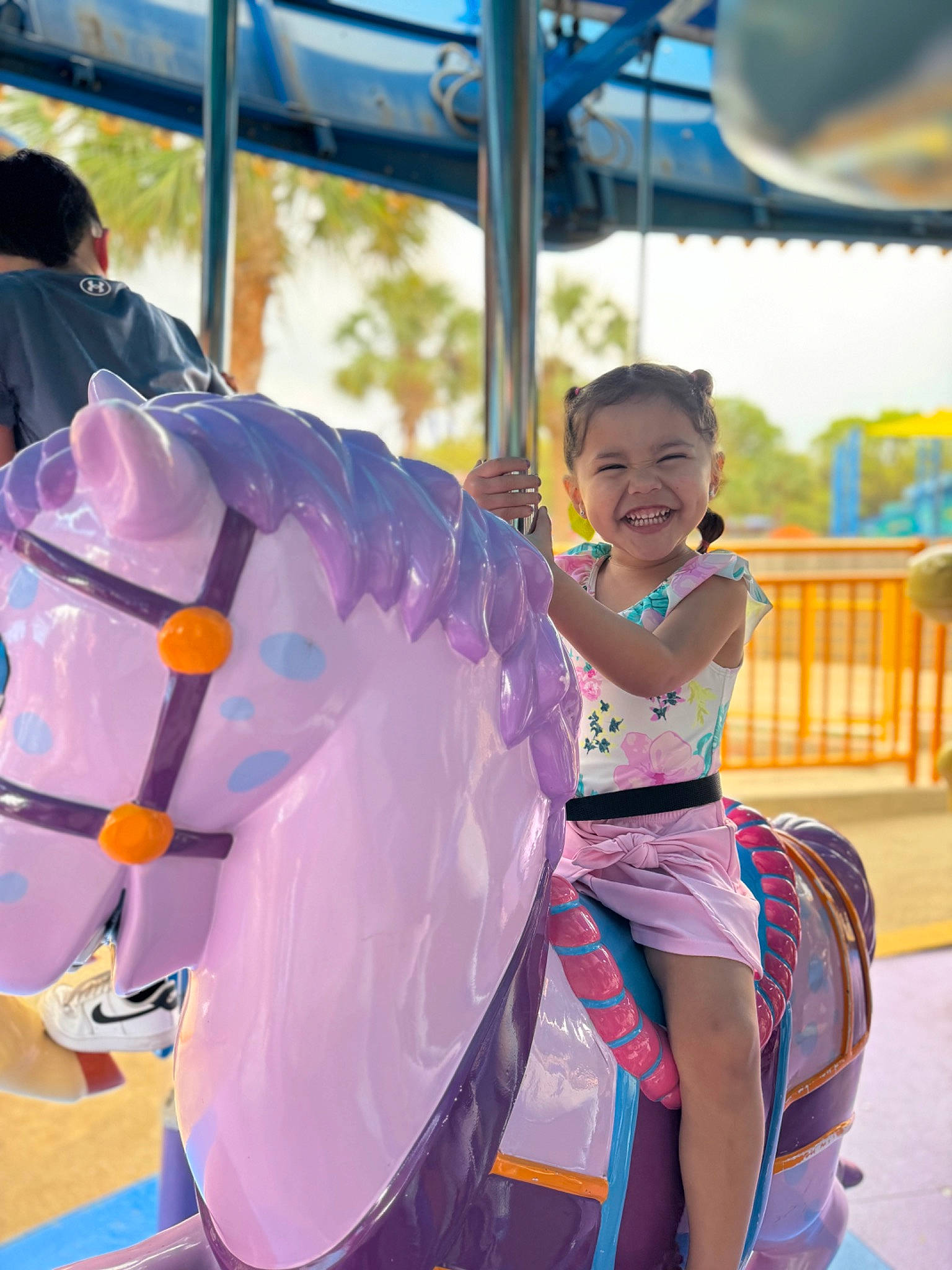 Camila Rae is registered to the contest to win money with this photo: amusement_ride, child, city, event, festival, fun, happy, joy, leisure, magenta, nonbuilding_structure, outdoor_play_equipment, person, pink, playground, public_event, purple, recreation, smile, snapshot
