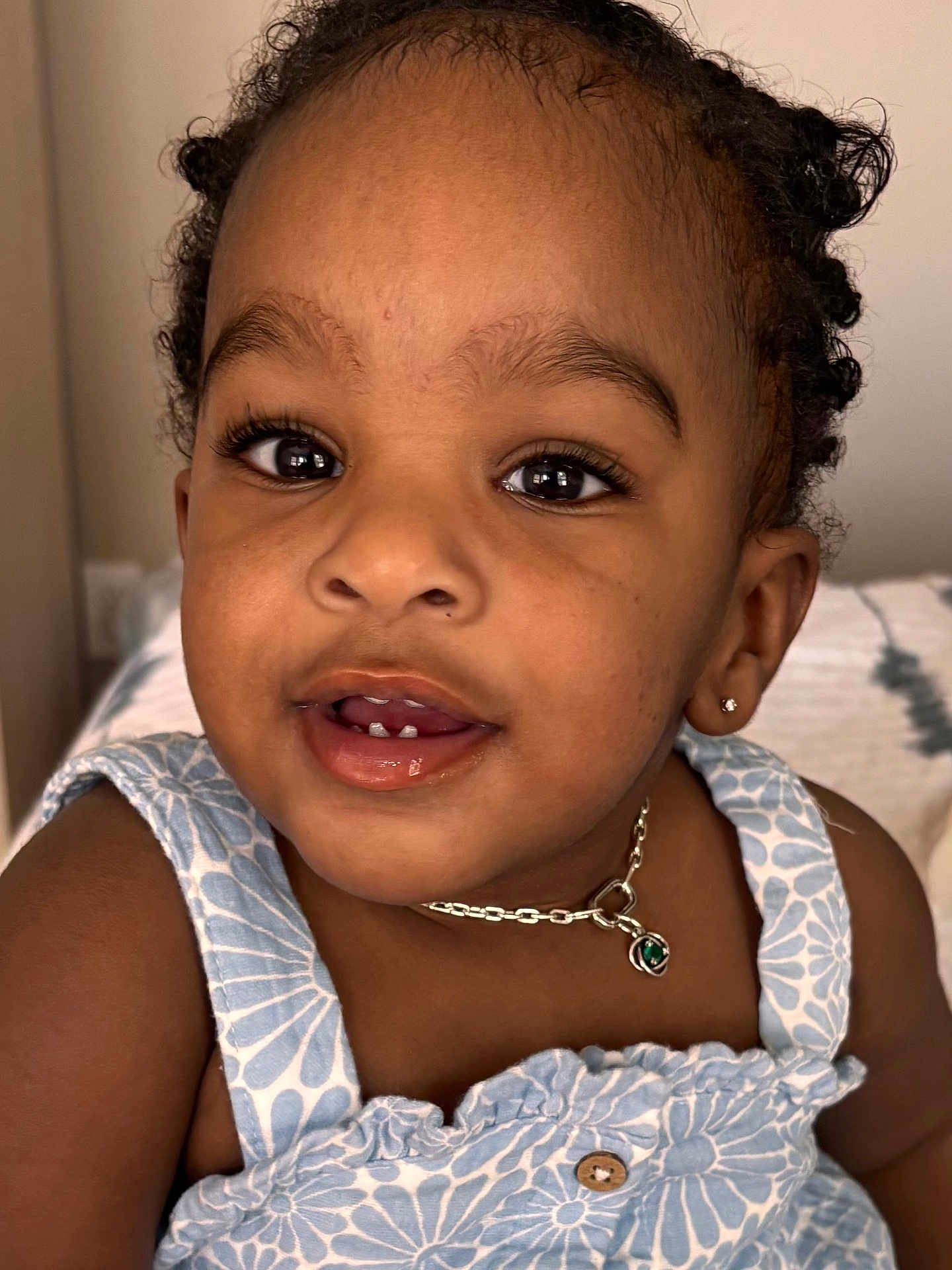 Bella joined the competition — help win amazing prizes! toddler, child, face, portrait, smile, blue_dress, necklace, earring, curly_hair, indoor, skin, eyes, mouth, cute, young_child, person, expression, closeup, fashion, happy