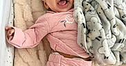 Aavani joined the competition — help win amazing prizes! baby, infant, crib, blanket, pink_clothing, smiling, happy, soft_texture, plush, sleepwear, cozy, child, cute, lying_down, indoor, comfort, face, head, blanket_pattern, star_pattern