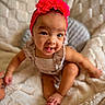 Aavani is registered to the contest to win money with this photo: baby, child, headband, flower, red, cute, smiling, face, skin, eyes, blanket, soft, texture, sitting, indoors, infant, playful, expression, clothing, portrait