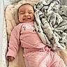 Aavani is registered to the contest to win money with this photo: baby, infant, pink_clothing, blanket, crib, soft_texture, smiling_face, cute, cozy, sleepwear, patterned_blanket, fluffy, indoor, child, person, portrait, lying_down, infant_face, home, comfort