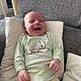 Harry participe au concours pour gagner de l'argent avec cette photo : baby, smiling, infant, pajamas, couch, pillows, happy, face, child, indoors, clothing, sitting, cute, home, relaxing, person, soft, furniture, portrait, cozy