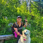 Ouna participe au concours pour gagner de l'argent avec cette photo : backpack, bench, cap, dog, forest, fur, greenery, happy, hiking, mountain, nature, outdoor, pet, smile, summer, sunlight, tag, trail, walking_stick, woman