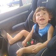 Braxton joined the competition — help win amazing prizes! child, toddler, car_seat, car_interior, smiling, happy, curly_hair, blue_shirt, seatbelt, window, vehicle, daylight, sitting, safety, cute, baby, young_child, car, automobile, seat