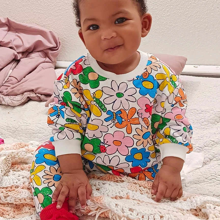 Elodaya is registered to the contest to win money with this photo: baby, bodypart, clothing, crawling, electronics, face, finger, hand, happy, head, hosiery, mobilephone, person, phone, photography, portrait, sitting, sleeve, smile, sock