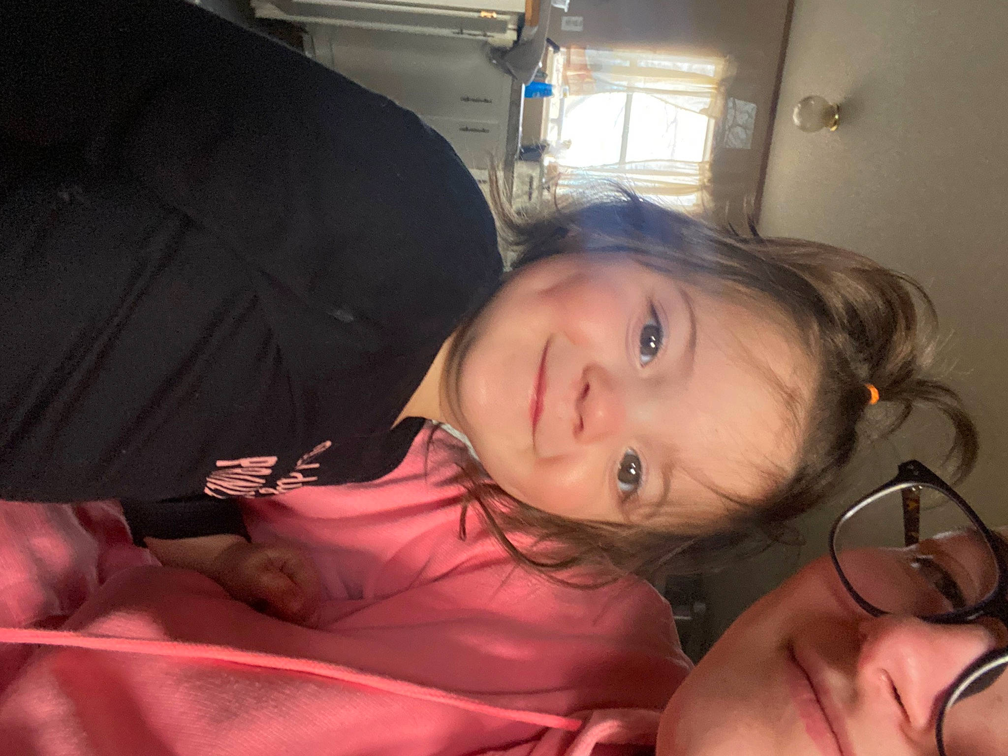 Everleigh is registered to the contest to win money with this photo: black_hair, brown_hair, cheek, child, comfort, couch, ear, eyelash, flash_photography, fun, happy, human_leg, joy, lip, long_hair, mouth, nose, person, sitting, skin