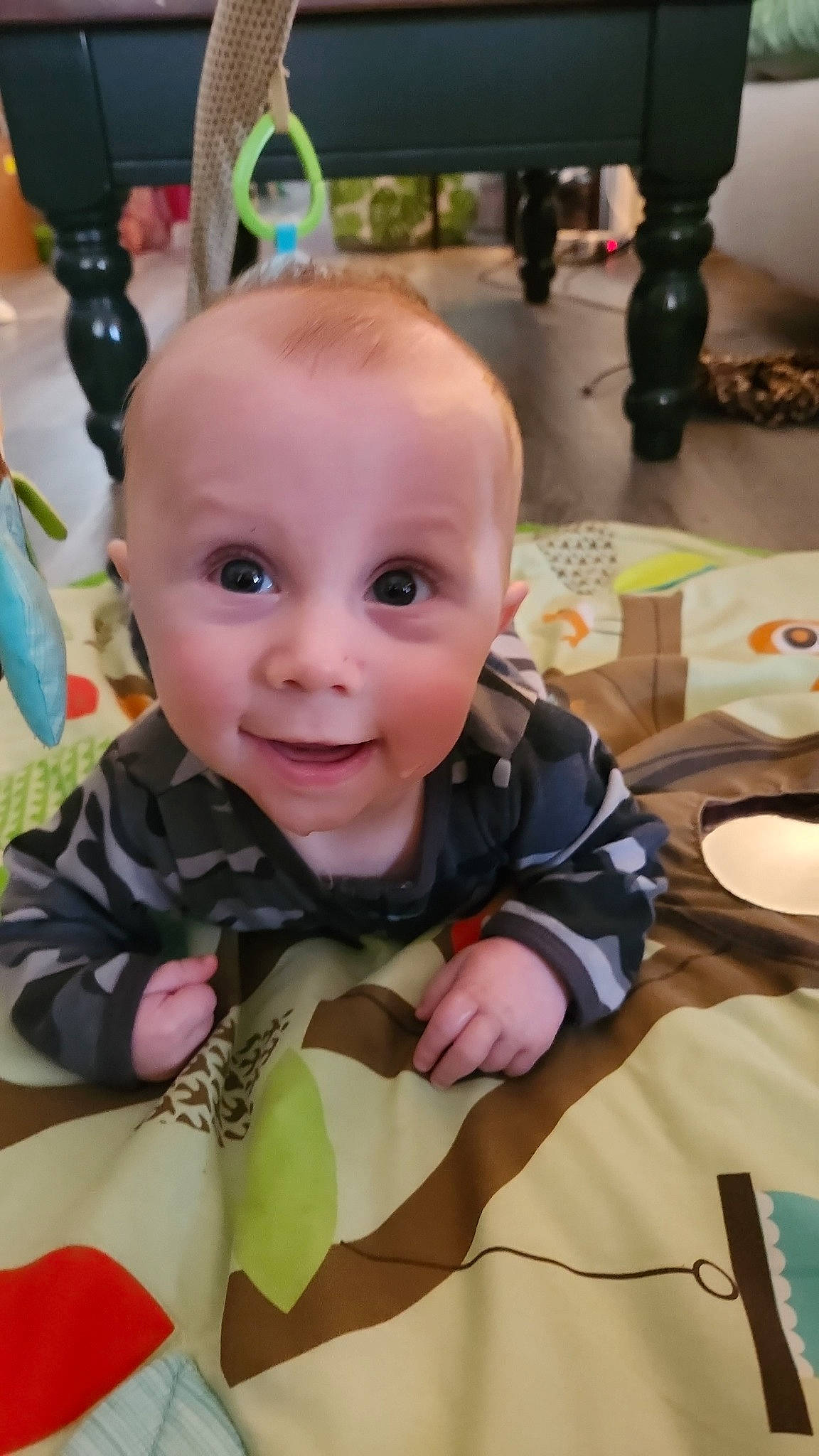 Malachai is registered to the contest to win money with this photo: baby, baby_products, baby_toddler_clothing, cheek, child, eye, face, flooring, fun, happy, head, iris, person, room, sitting, skin, sleeve, smile, t_shirt, toddler