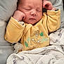 baby, blanket, closeup, cozy, cute, face, hand, indoors, infant, newborn, pacifier, peaceful, pillow, resting, simba, sleeping, soft_texture, star_pattern, wrapped, yellow_clothing