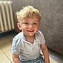 Maylone a rejoint le concours — aidez-le/la à gagner de superbes lots ! blond_hair, blue_eyes, casual_clothing, child, couch, cute, floor, happy, indoor, light, patterned_pants, person, polo_shirt, portrait, radiator, sitting, smile, tile_floor, toddler, young_child