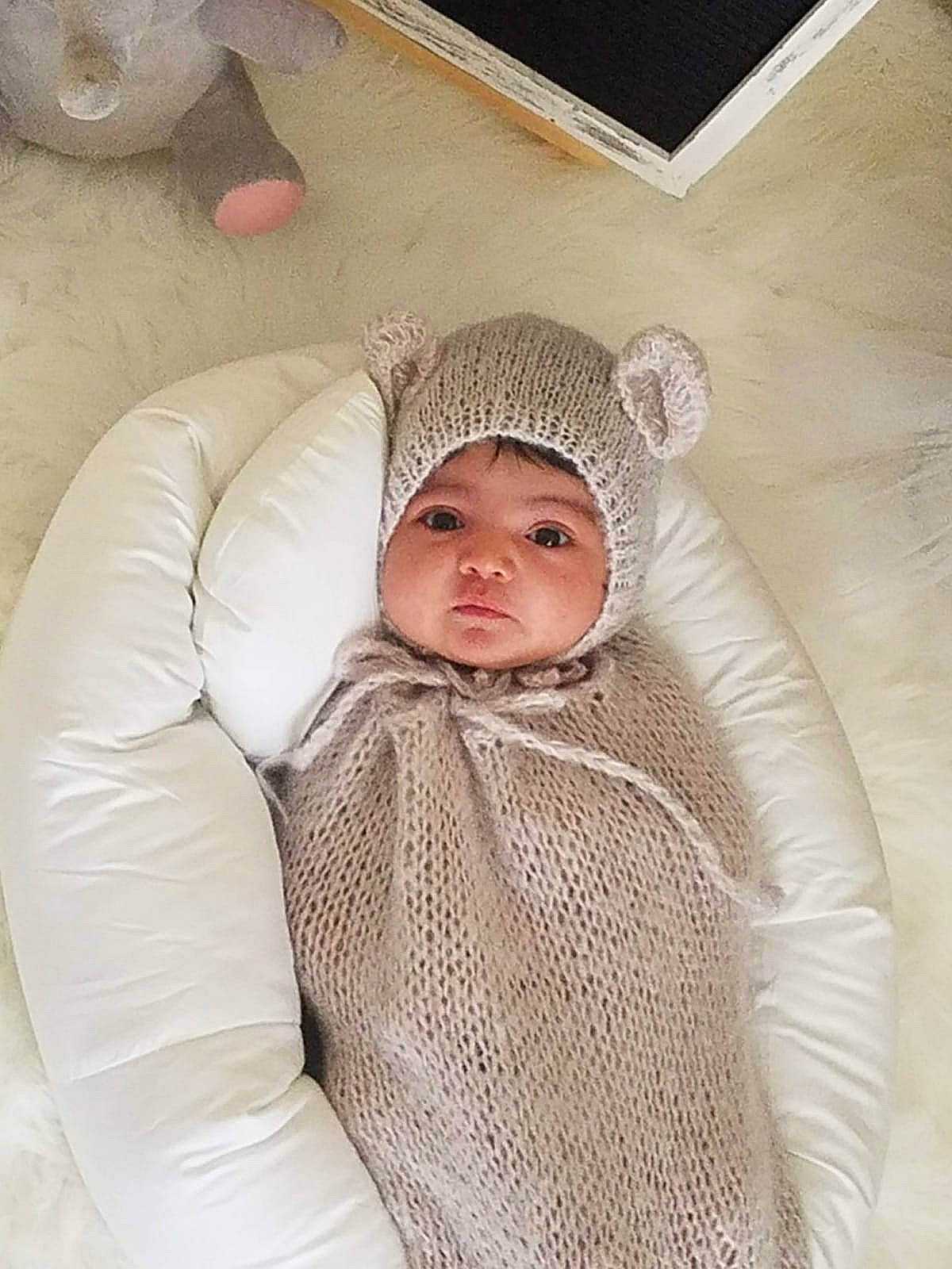 Alyssa is registered to the contest to win money with this photo: baby, baby_products, baby_sleeping, baby_toddler_clothing, cheek, child, chin, comfort, eye, eyebrow, fashion_accessory, flooring, fur, headwear, human_body, knit_cap, linens, person, sleeve, toddler
