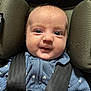 baby, infant, car_seat, straps, blue_clothing, cute, smiling, face, head, child, seatbelt, safety, portrait, expression, young, person, baby_clothes, closeup, indoor, child_safety