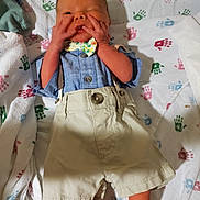 Parker is registered to the contest to win money with this photo: accessories, baby, bed, bodypart, clothing, couch, face, finger, formalwear, furniture, hand, hat, head, newborn, pants, person, photography, portrait, shorts, tie