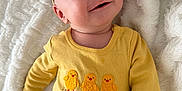 Elizabeth joined the competition — help win amazing prizes! baby, infant, child, smiling, headband, bow, onesie, yellow_clothing, chick_embroideries, buttons, brown_pants, looking_up, happy, blanket, soft_texture, cozy, portrait, close_up, indoor, newborn